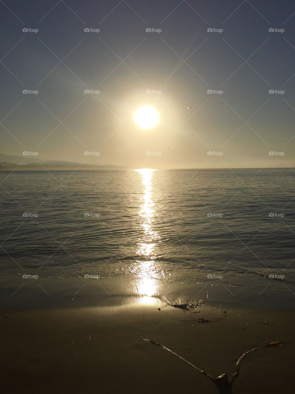 Sunrise at Santa Barbara. Bright sun, dark edges. Sun reflecting on water. 