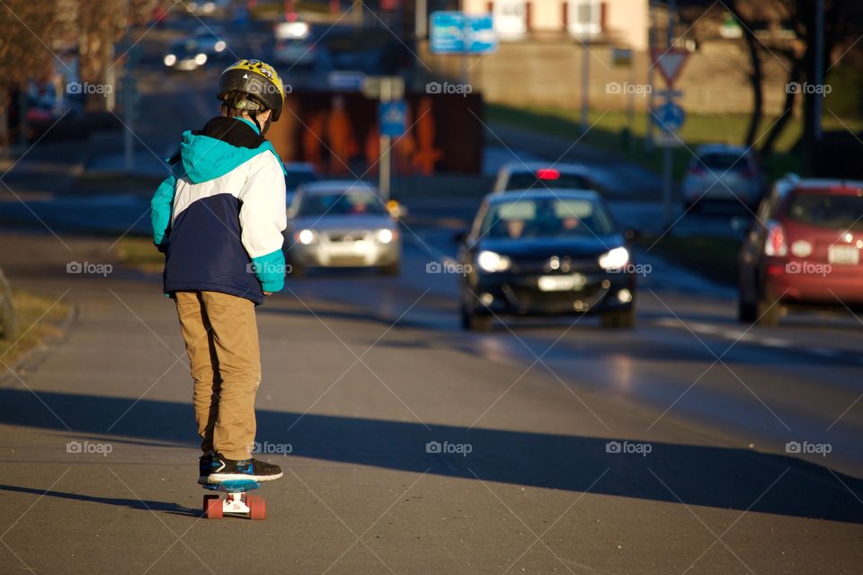 Boy skateboarding on road