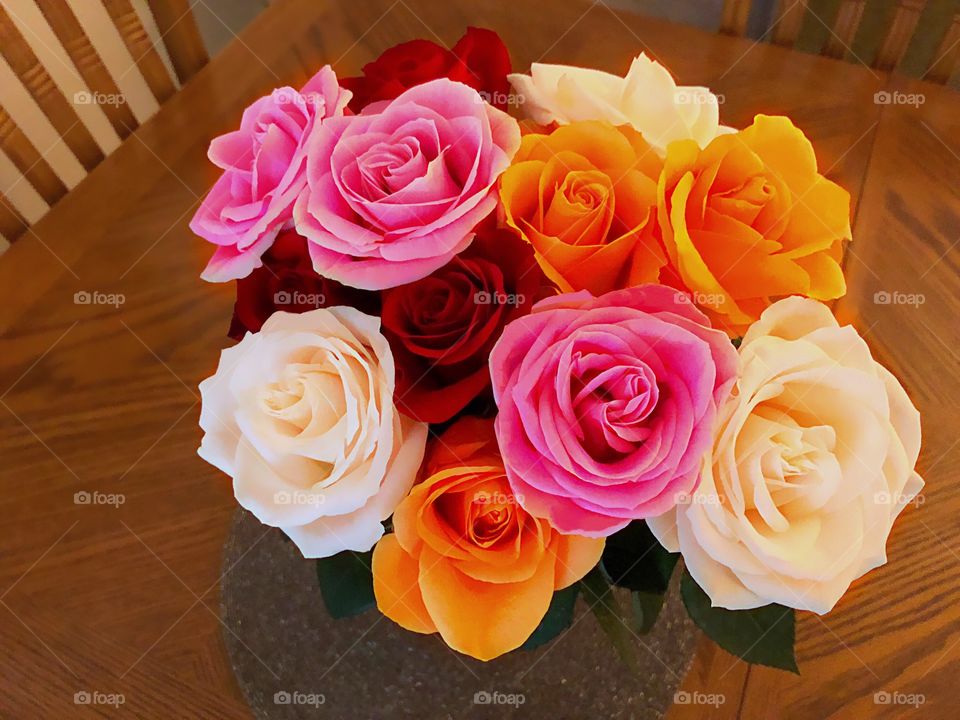 Multicolored rose bouquet bursting in vibrant shades.