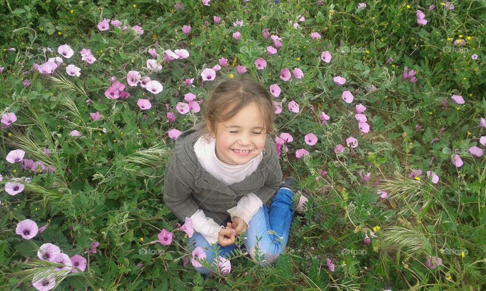 Happy little girl and flowers