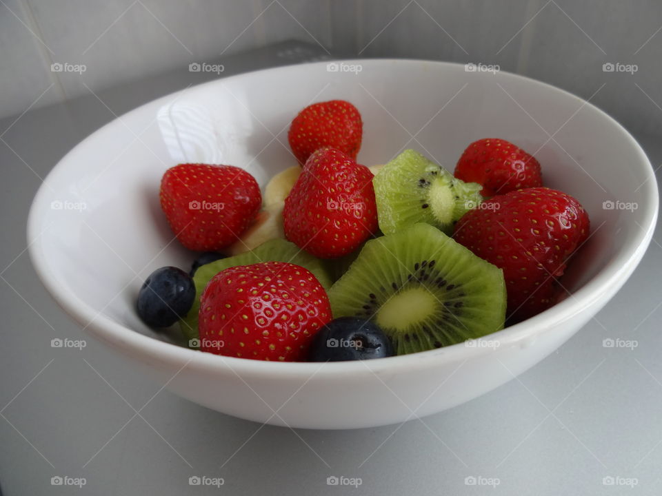 Healthy fruits breakfast full of vitamins with strawberry, kiwi, banana and berries