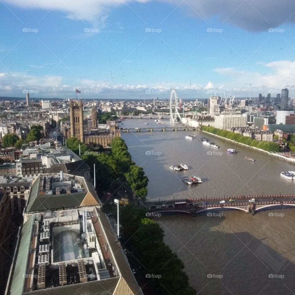 Building bridges London eye boats and London skyline River Thames
