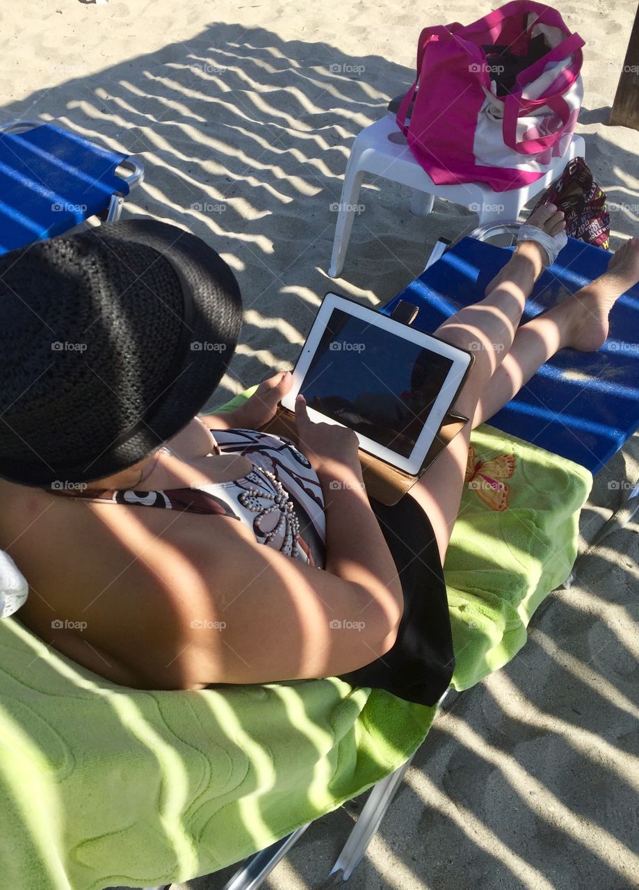 Woman at the beach under the shelter