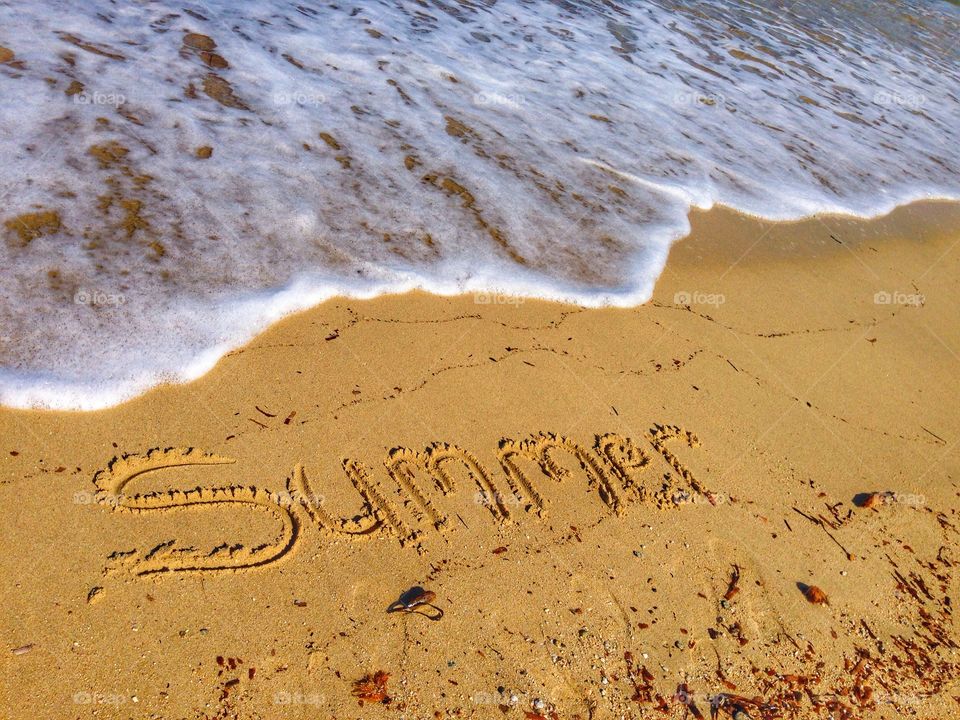 High angle view of summer text on sand 