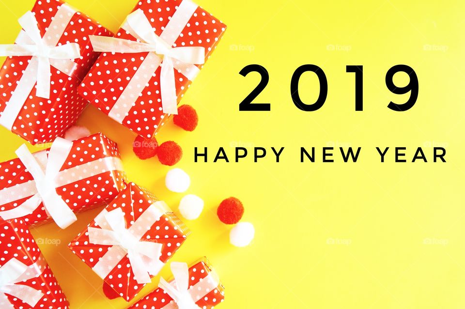 Happy new year 2019 with gift box,balls on yellow background 