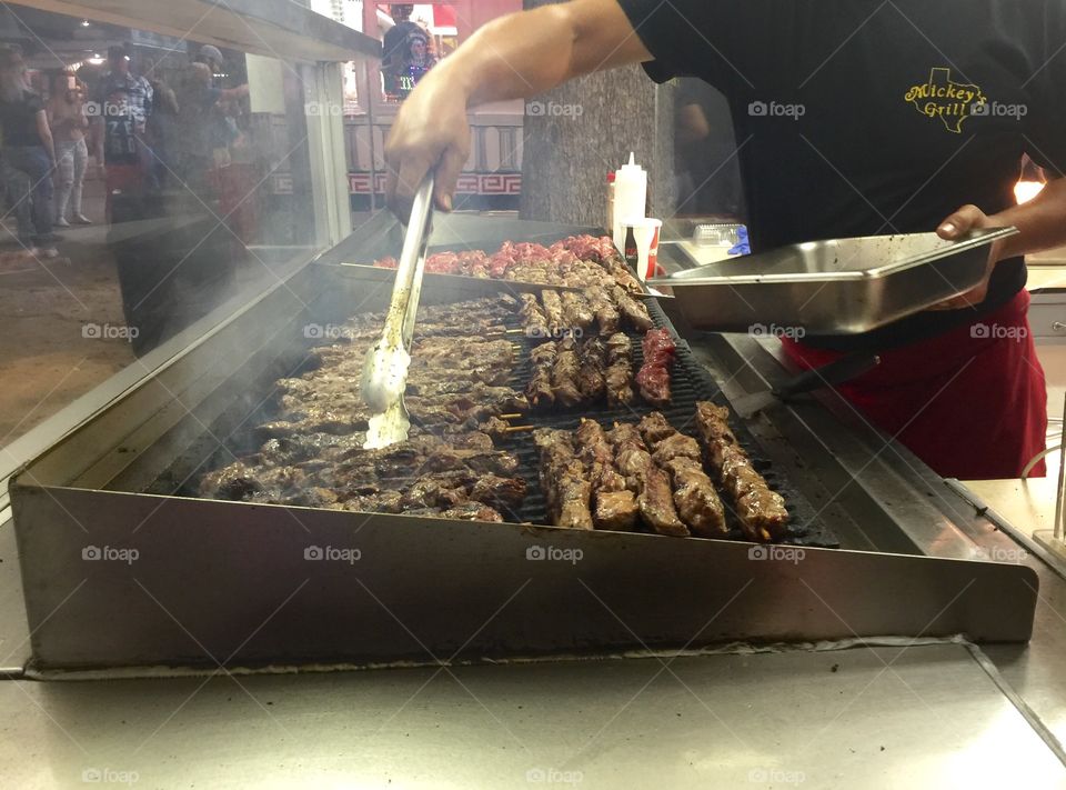 Delicious meat kabobs being grilled by s street vendor
