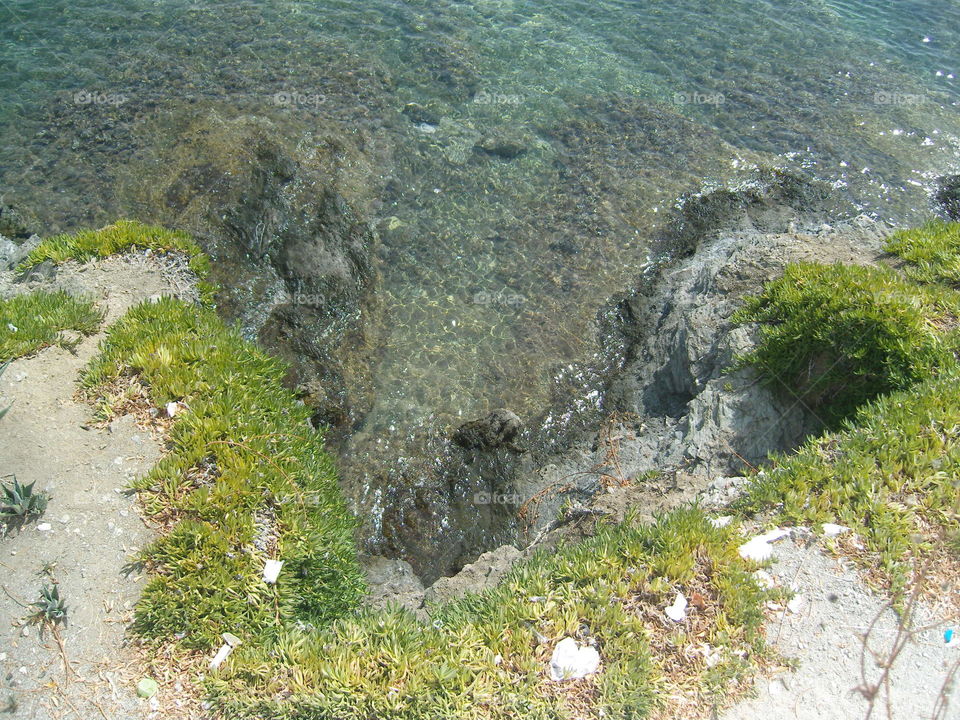 Steep sea shore and clear water