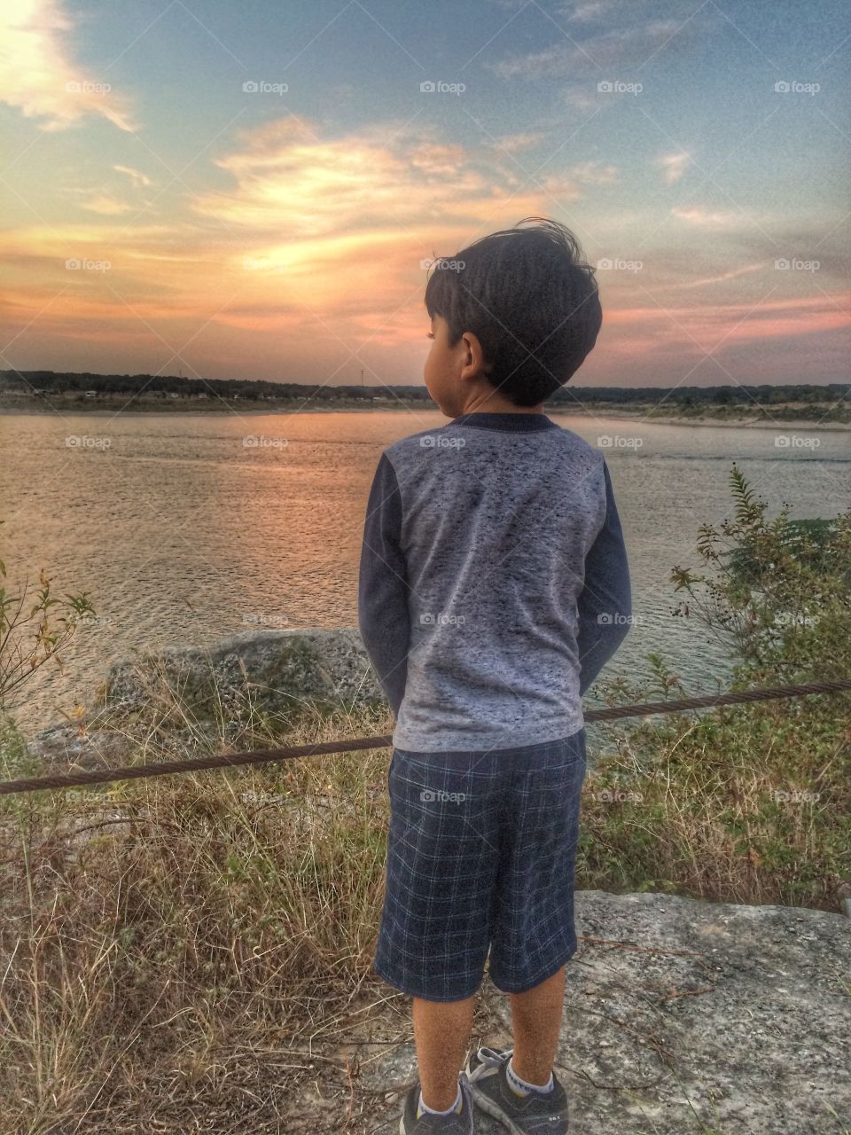 Boy overlooking the lake