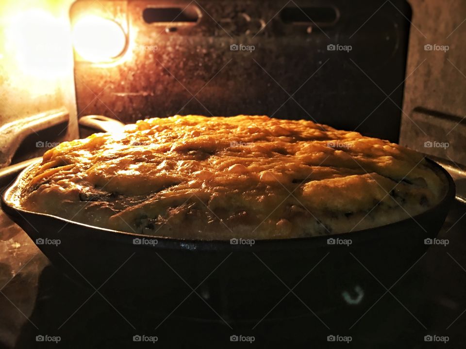 Quiche in the oven with melted cheese