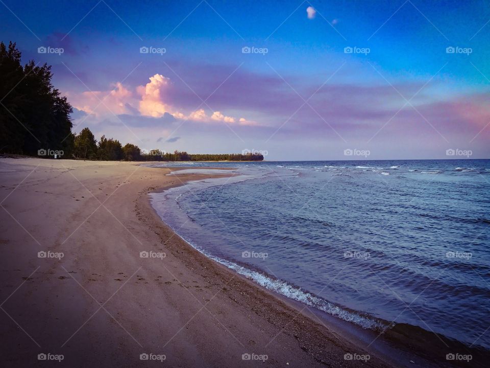 Romantic holiday vacation on tropical sandy beach seaside during sunset in southern Thailand - colorful ocean theme background