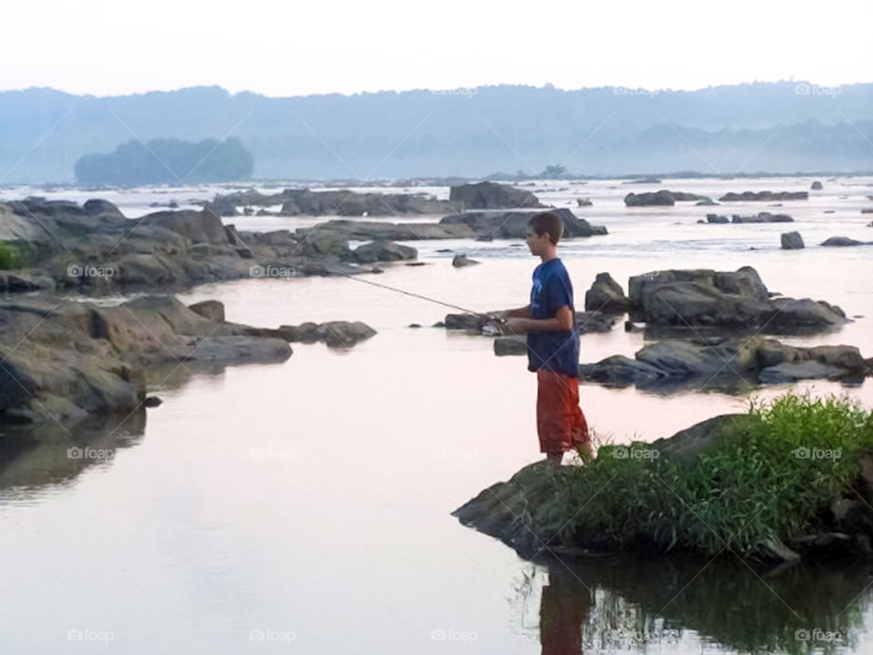 boy fishing. early morning fishing on the Susquehanna river