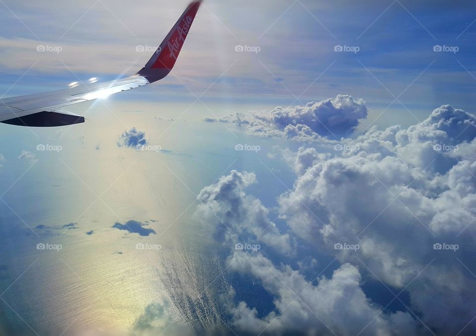 Up from above the gorgeous  view of Bangkok. Ocean, sun, clouds and reflection.