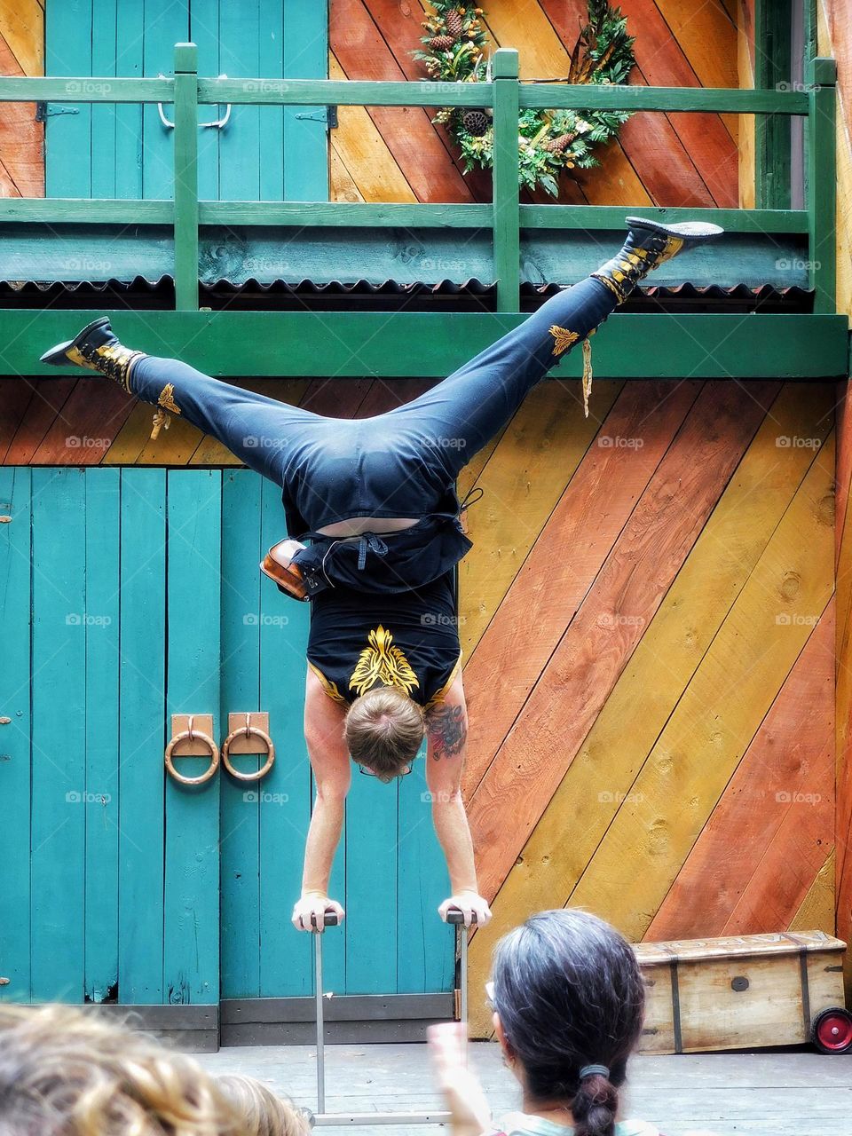 Acrobat on stage doing a handstand 