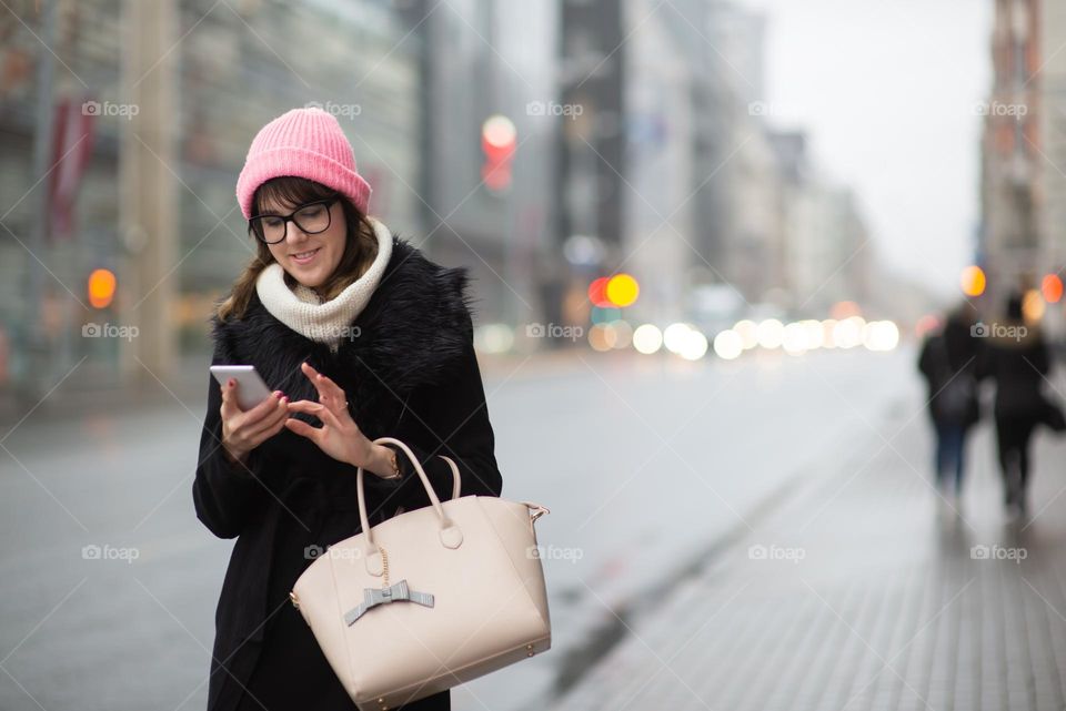 Woman using phone in the city