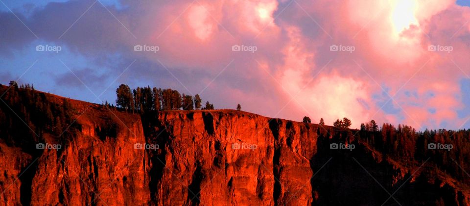 Cliffs at sunset with pink clouds above in a stormy sky