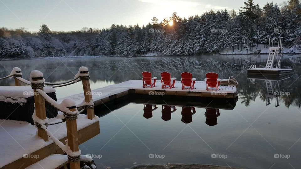 Red Adirondack Chairs at the Lake