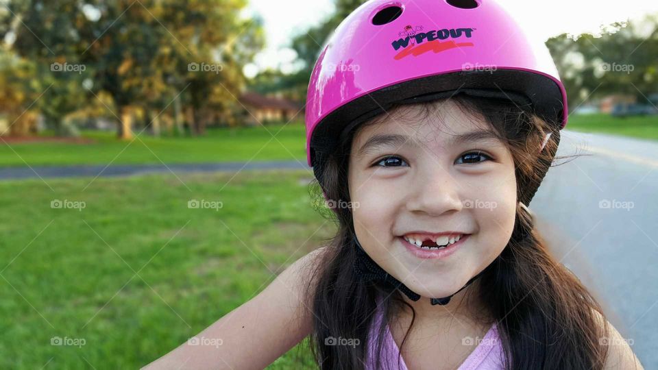 Happy girl wearing helmet