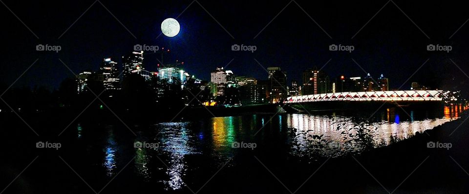 Full moon over Calgary. Summer night, blue moon, Peace Bridge, making love on a bench in the park, cops show up, cctv cameras everywhere