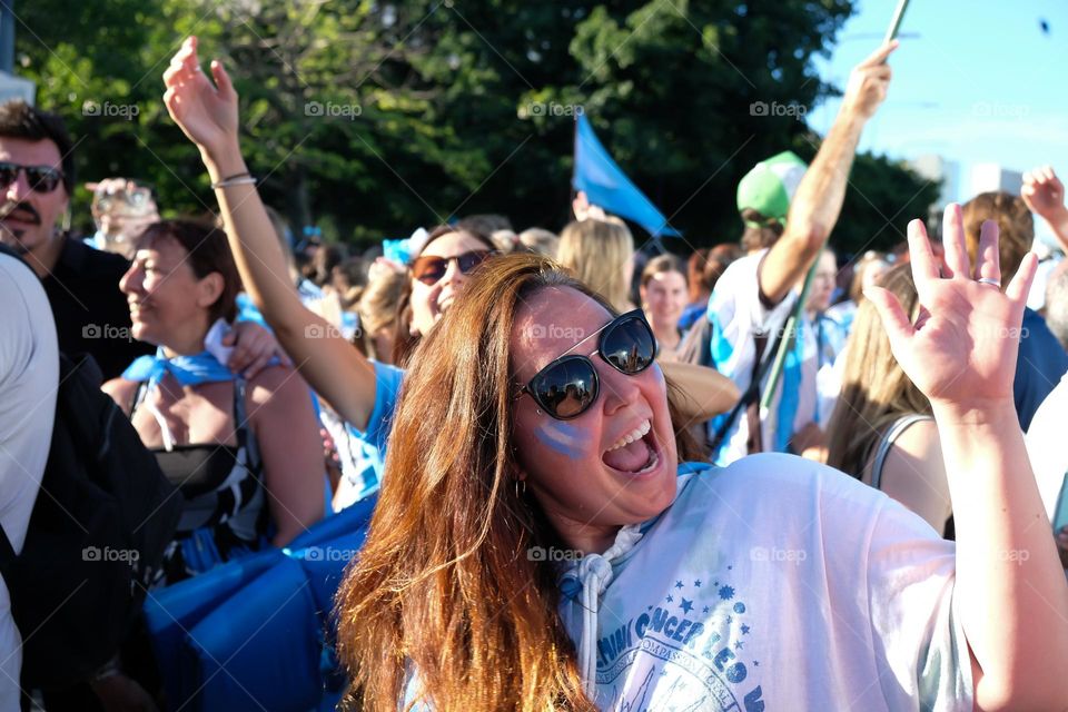 Buenos-Aires - 18.12.2022: Football fans of national team of Argentina in t-shirts on national team celebrating victory on the streets