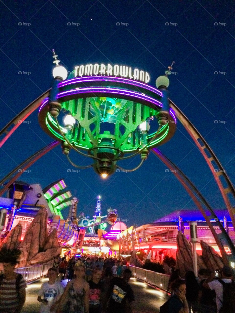 Tomorrowland Disney World. It's dusk. The neon is a glow as you enter Tomorrowland. 