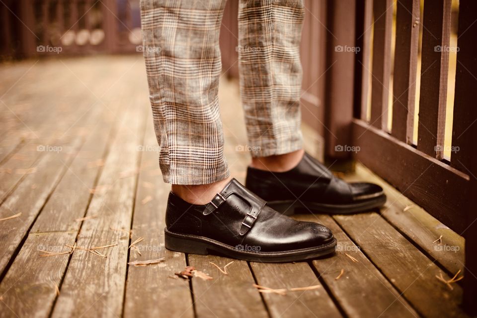 on the autumn terrace milenial guy stands in boot