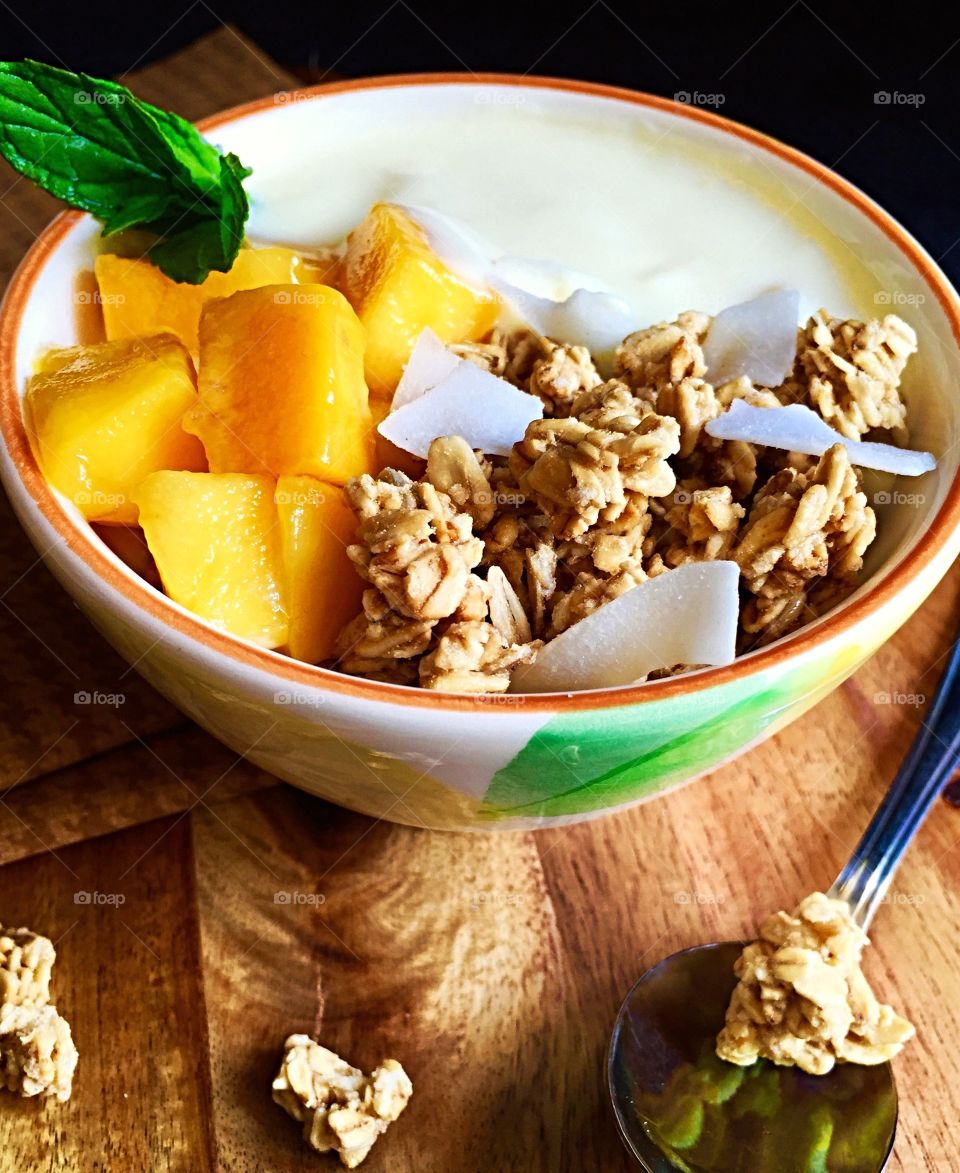 Mango coconut flakes and granola breakfast 