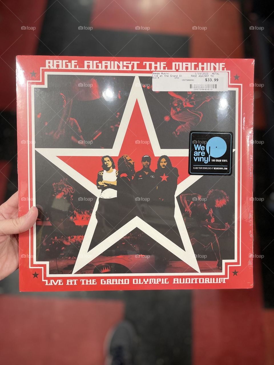 Woman’s hand holding Rage Against The Machine vinyl, shopping for vinyls at a record shop, support your local record shop, shopping local, hipster buying records at a record shop, Rage Against The Machines album, shopping in Ohio