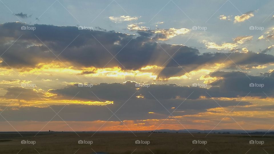 sunrise , sunrays illuminating the morning clod sky