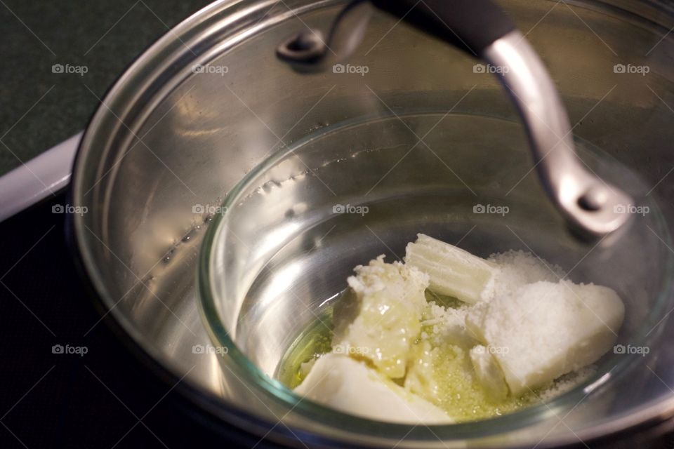 Combined ingredients for homemade skin care products being melted together using the double-boiler method