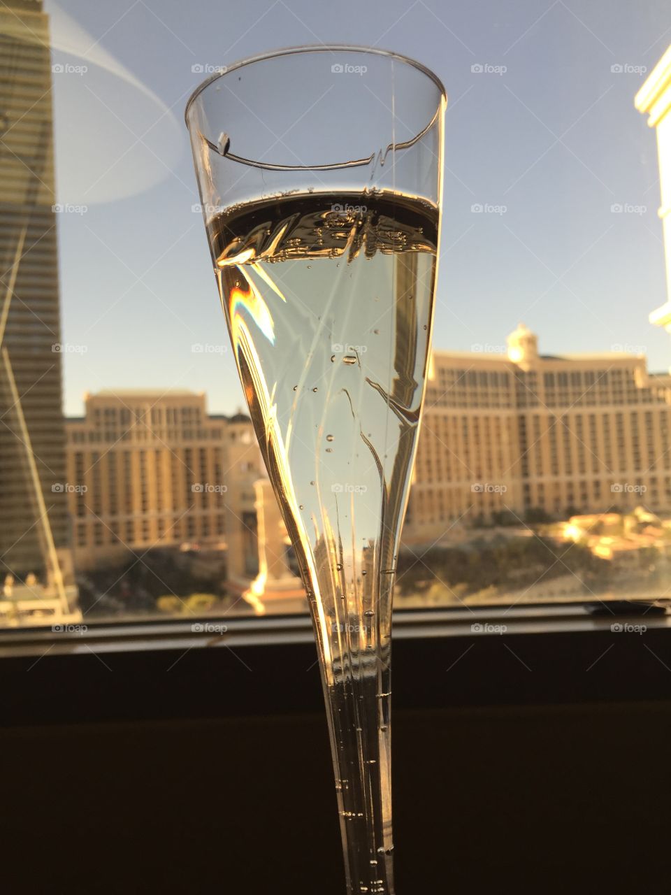 Cheers in Las Vegas.   A glass of champagne with The Bellagio in background 