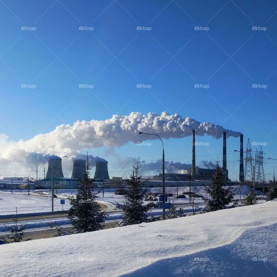 industrial area. the smoke from the chimney. a cold blue sky