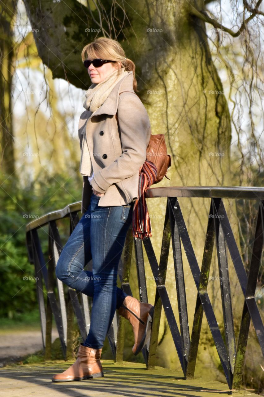 Woman stands on a bridge