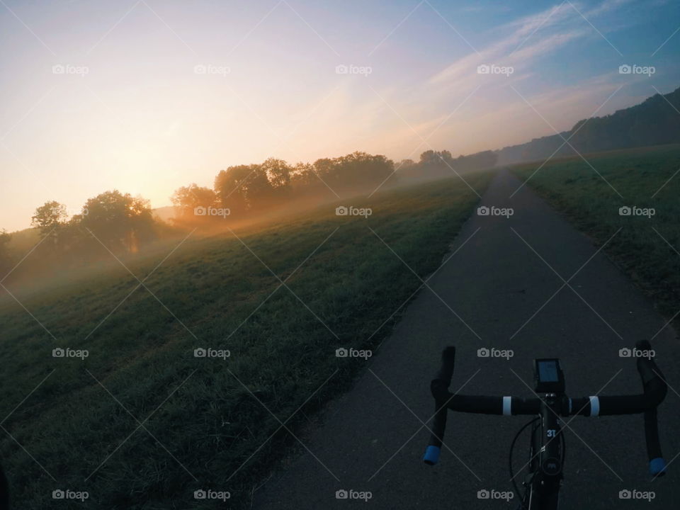 sunrise on a wonderful morning ride with a roadbike. It is end of summer and fog is on the fields. I love it. And you?