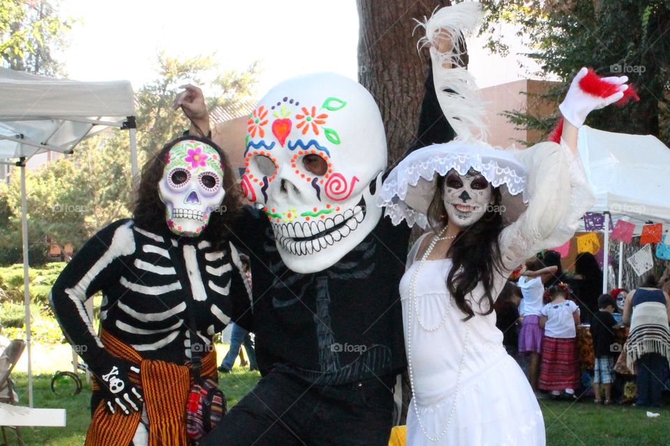 People dressed up as Day of the Dead characters during a Día de los Muertos Festival in the fall