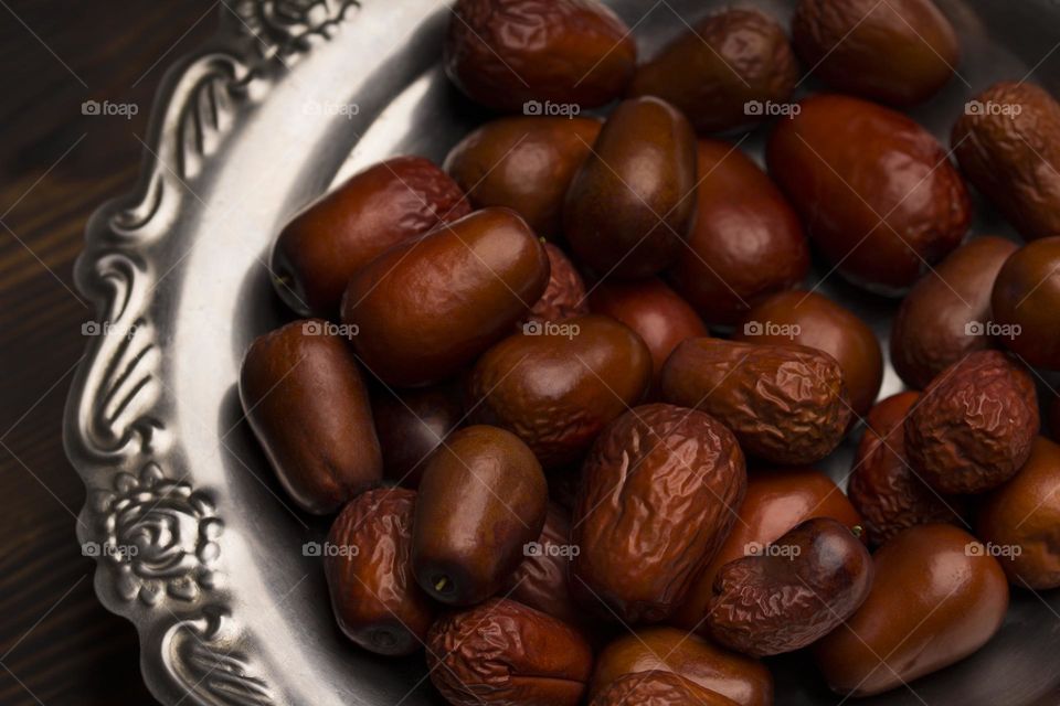 Date fruits on silver plate