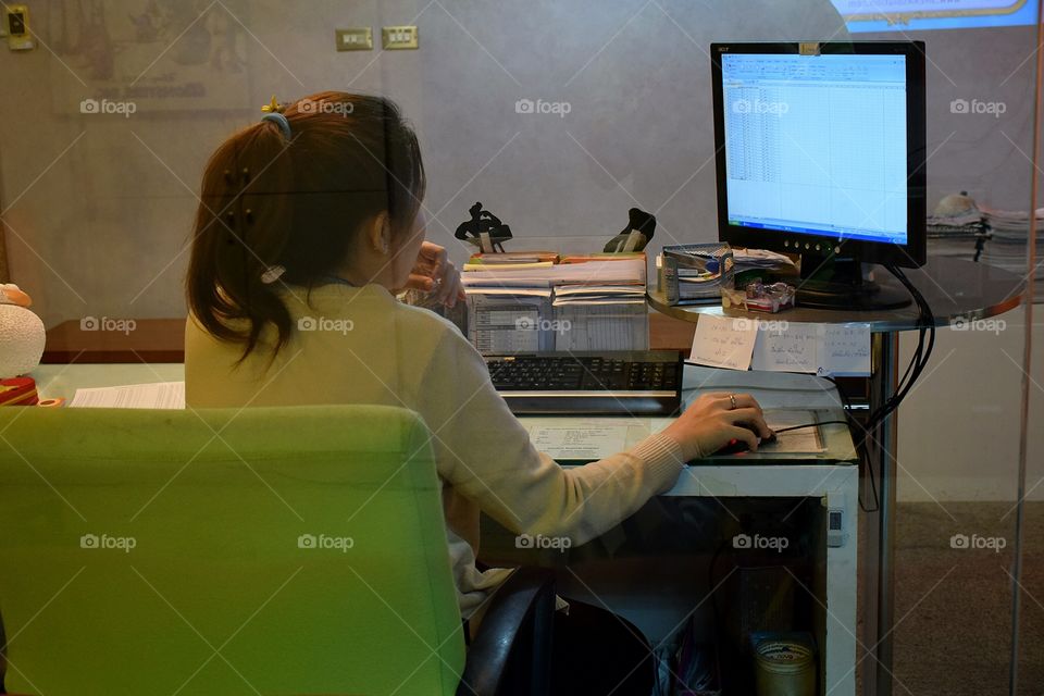 working. woman typing on a pc computer 