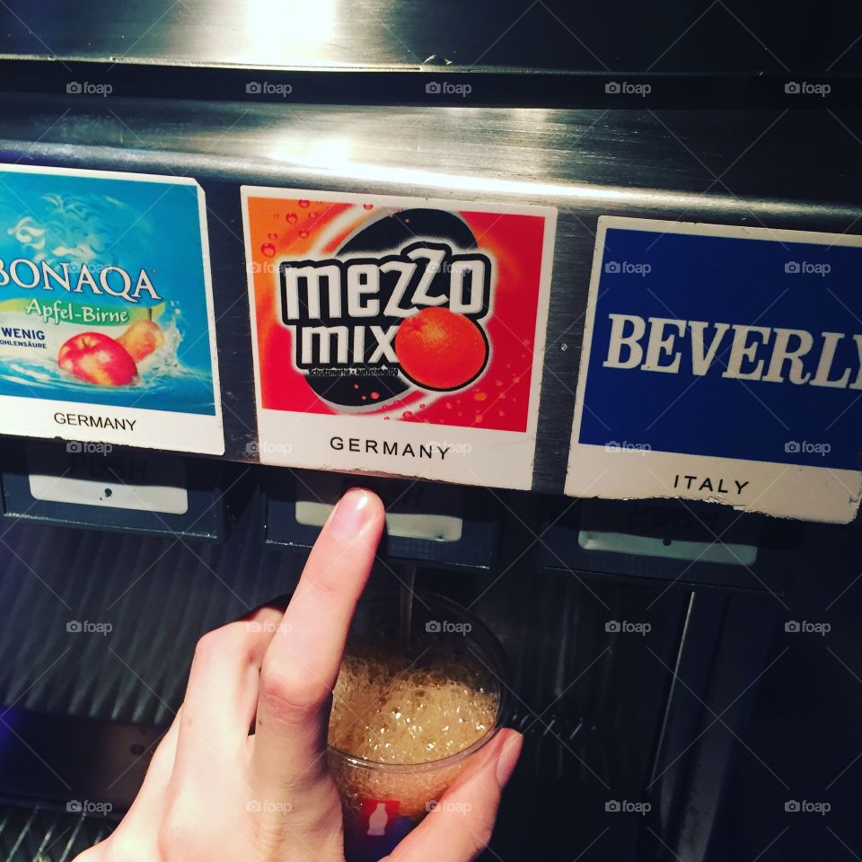 Person getting drink from soda fountain