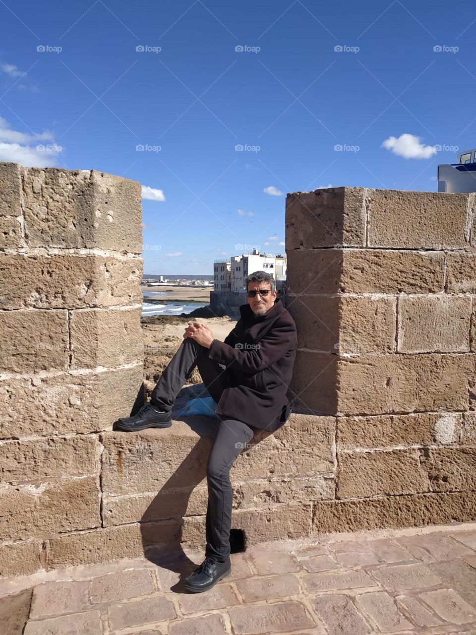 Im sitting on an ancient wall at essaouira city in Morocco.