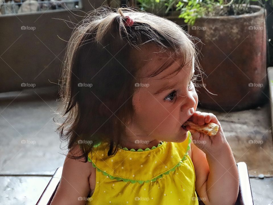 Toddler Eating A Snack. Little Girl Eating Pizza
