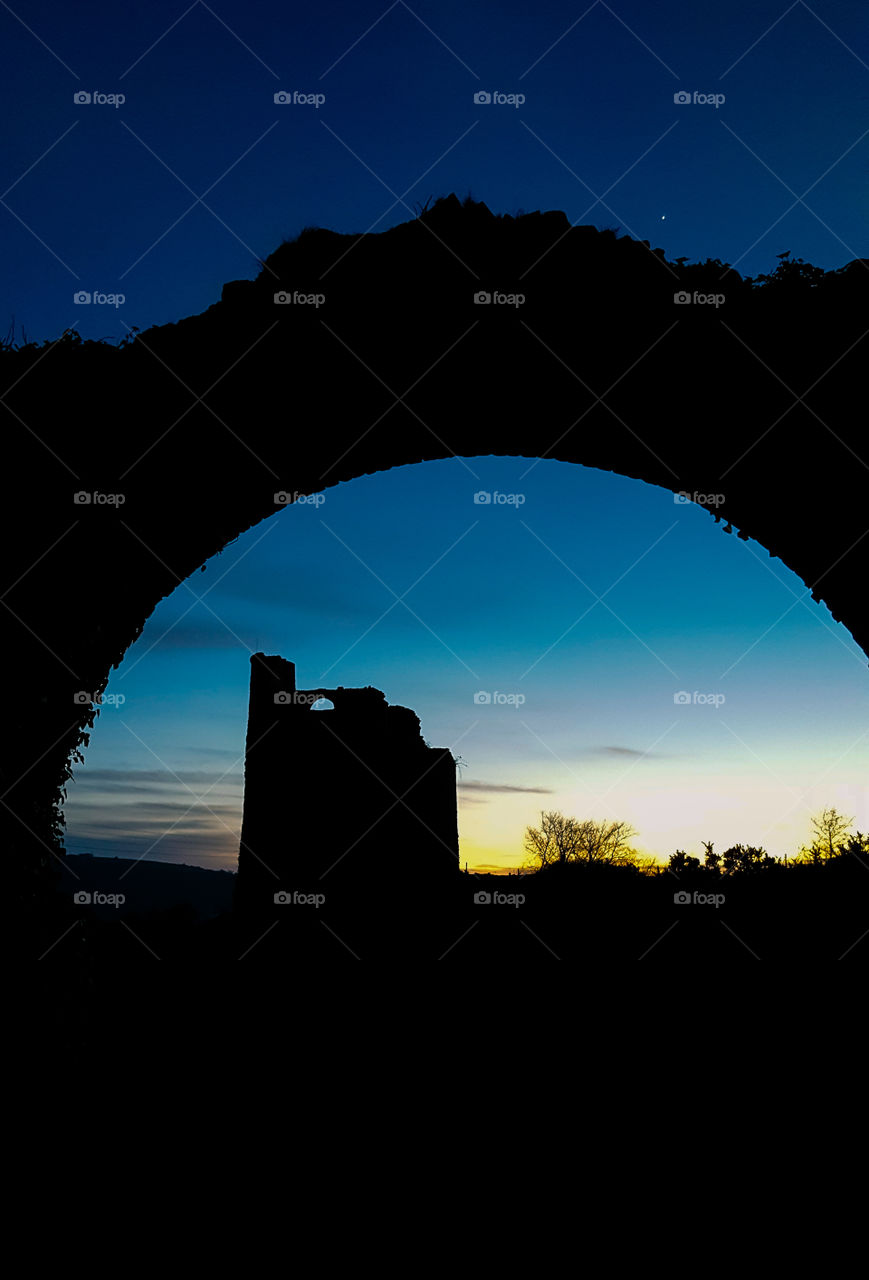 Sillouette through arch of stone