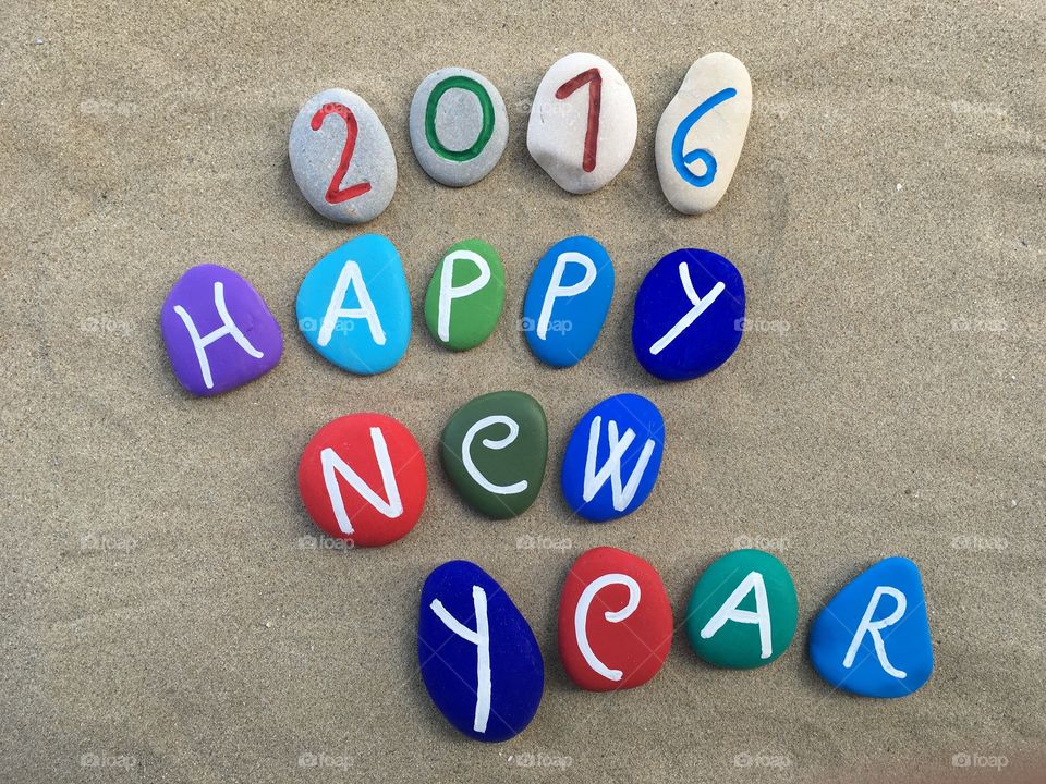 Happy New Year 2016, colored stones composition on the sand 