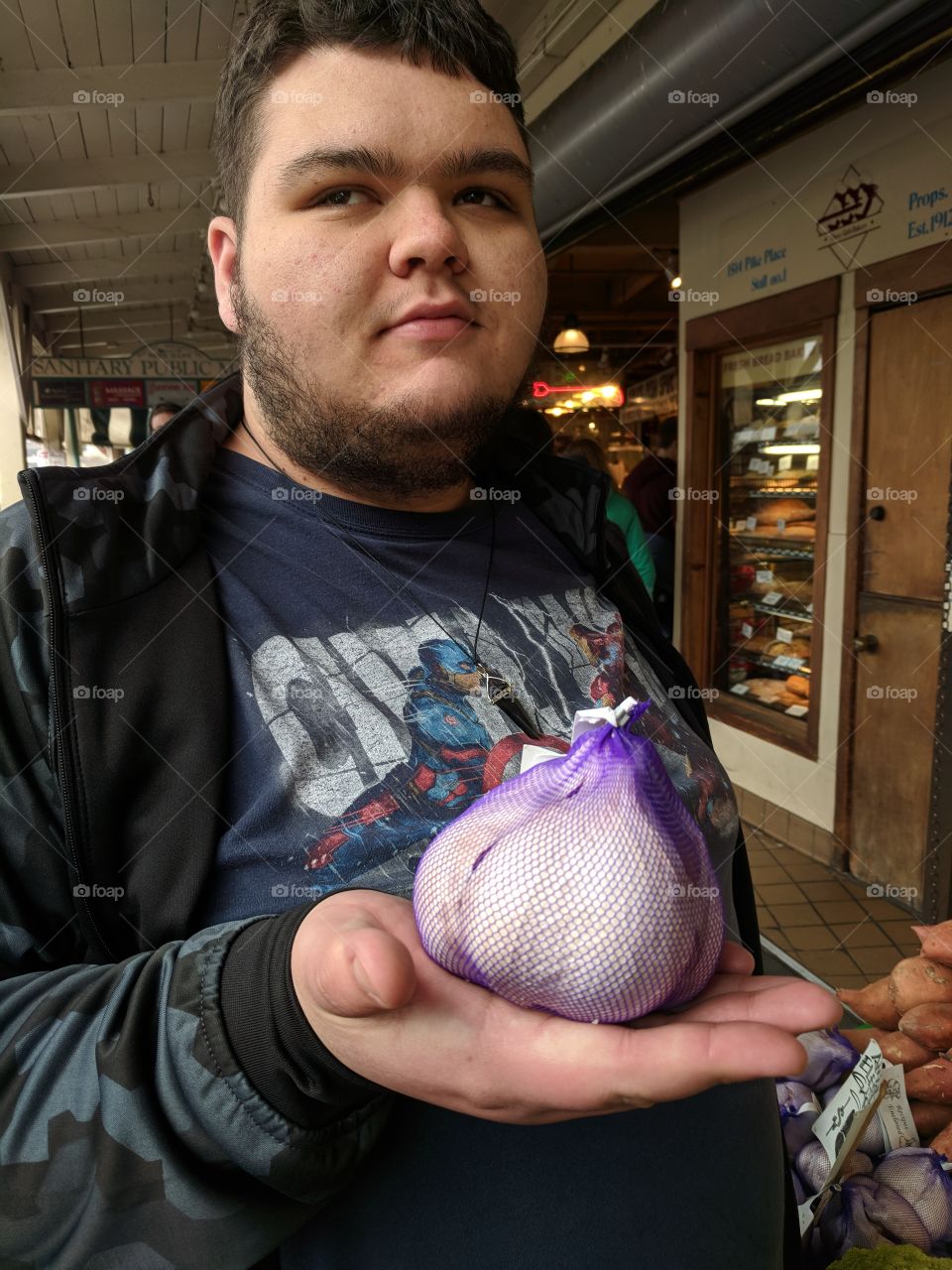 Showing off an enormous bulb of garlic!