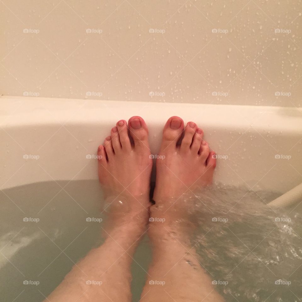 Closeup of woman's feet covered with bath great for any use.