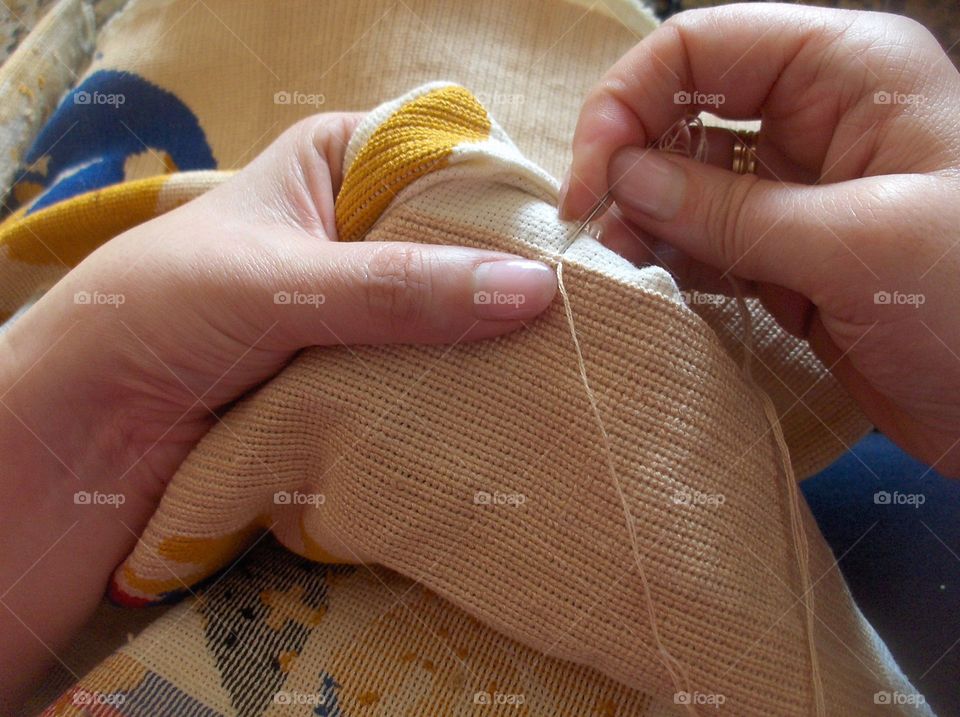 Female hand doing needlework
