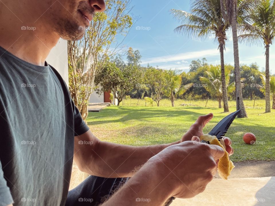 Moods of summer - man eating an orange on a hot summer day