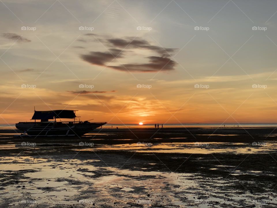 Silhouette of the boat and the sun set San Remigio Cebu Philippines.