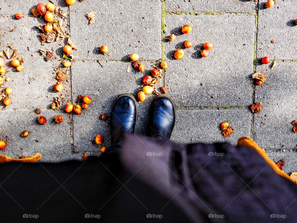 Fallen fruit and boots from above 