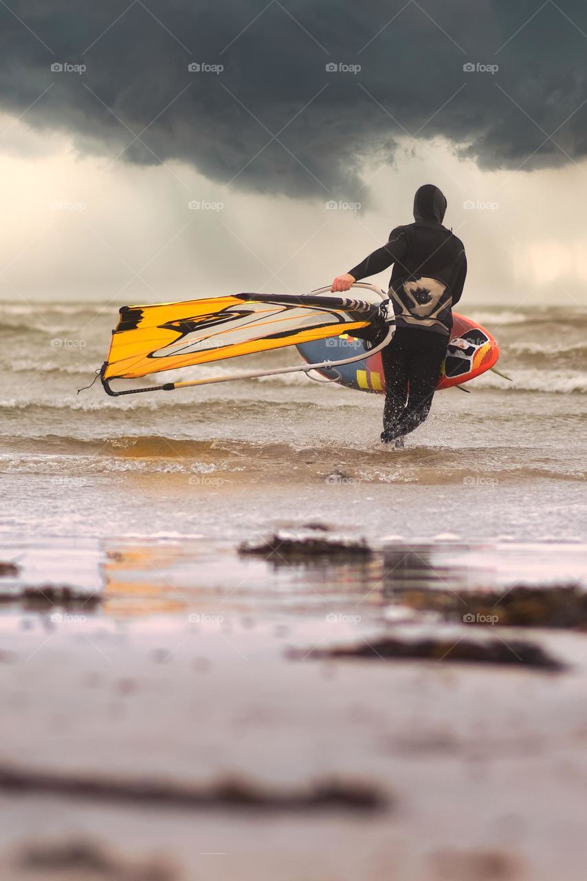 Surfer at Silverstrand beach in Galway, Ireland