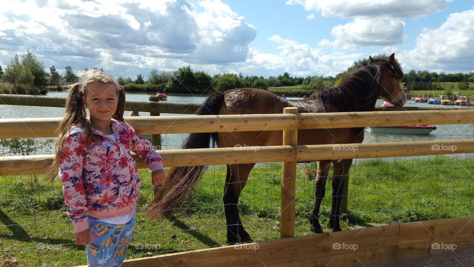 little 7 year old girl with a horse at twin lakes farm