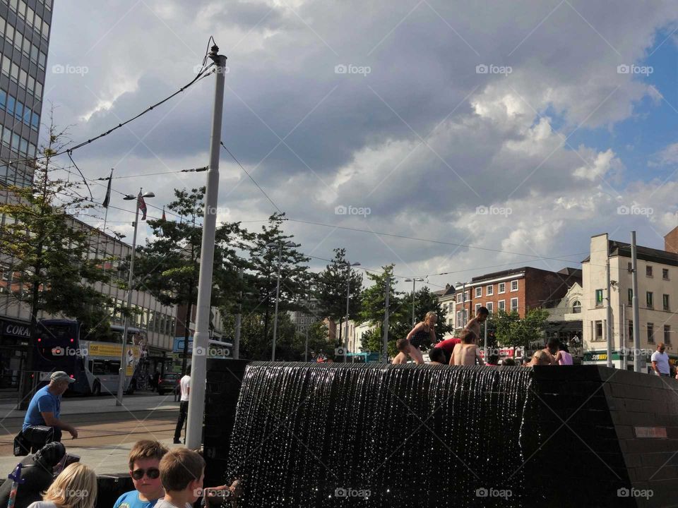 People cooling of in the fountains at Old Market Squar in city centre of Nottingham, England